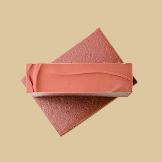 Two rectangular bars of soap stacked diagonally on a plain white background.