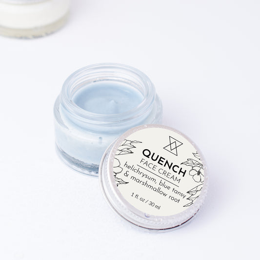 Jar of Quench face cream with an open lid on a light background