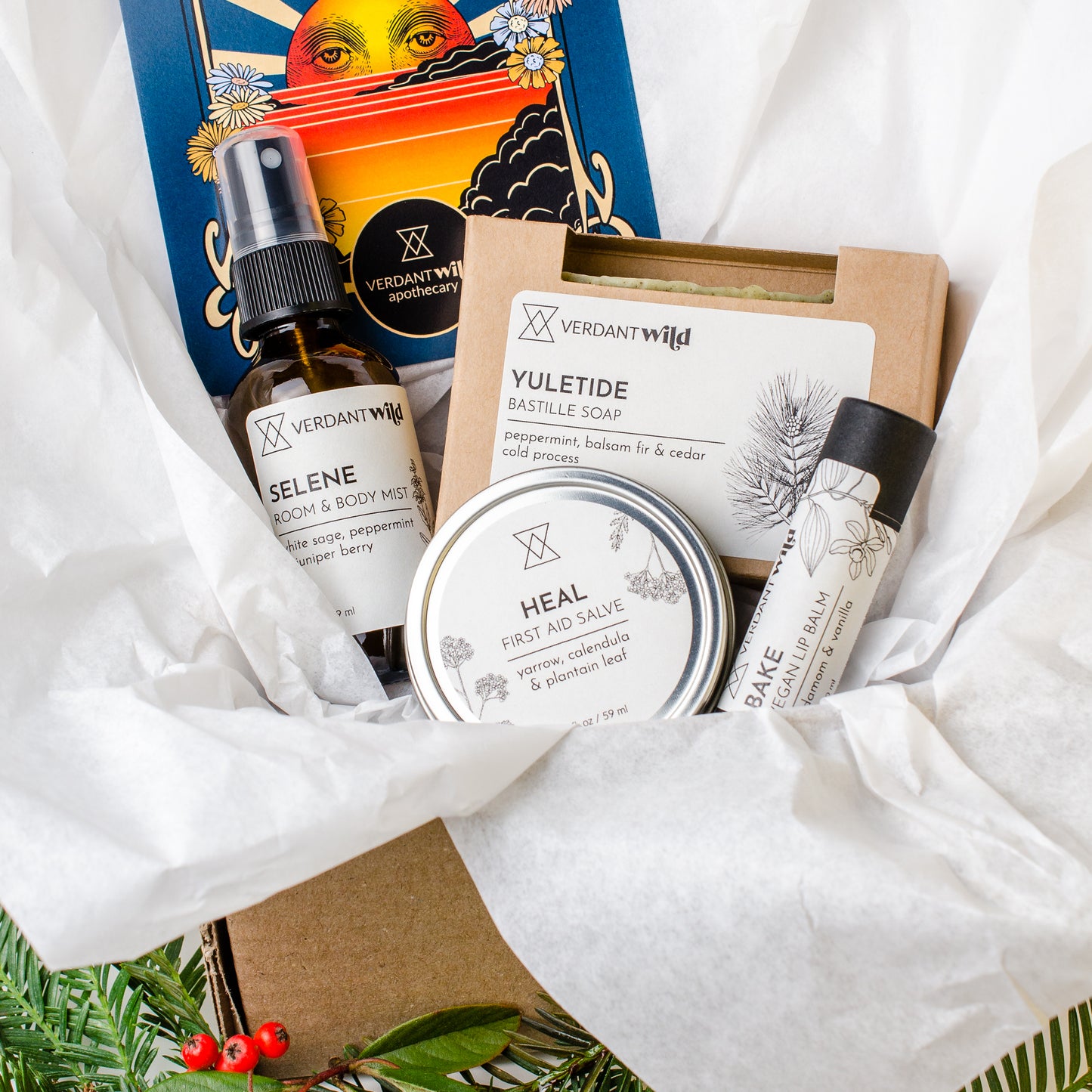 Collection of natural skincare products from Verdant Wild on a white fabric background