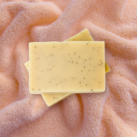 yarrow poppyseed soap, open on fuzzy pink towel