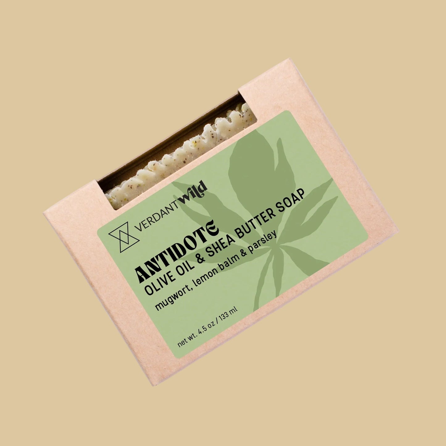 A rectangular kraft paper box of Verdant Wild Antidote Olive Oil & Shea Butter Soap. The box features a light green label with black text and a leaf graphic, and a small window at the top reveals the olive green soap bar inside.