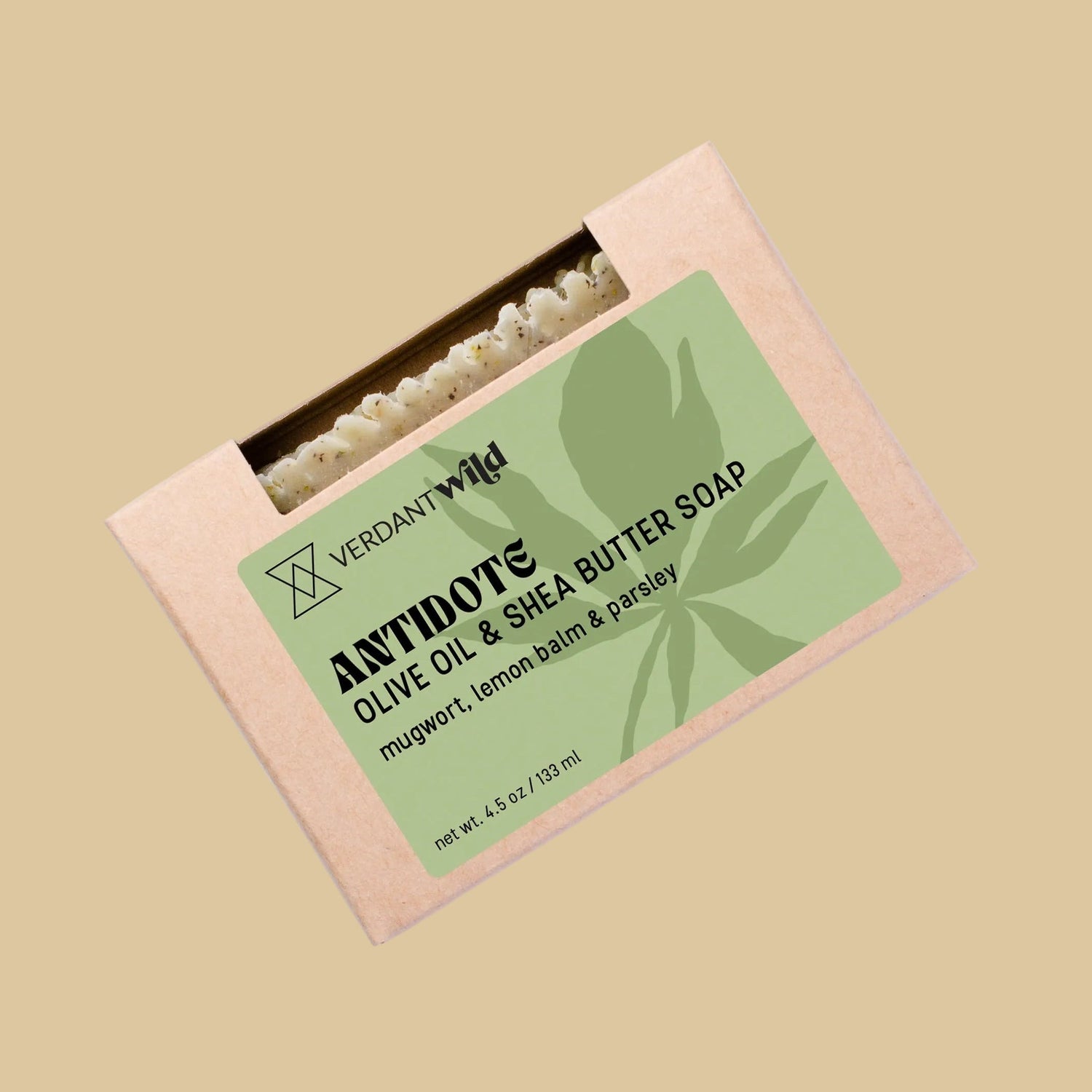 A rectangular kraft paper box of Verdant Wild Antidote Olive Oil & Shea Butter Soap. The box features a light green label with black text and a leaf graphic, and a small window at the top reveals the olive green soap bar inside.