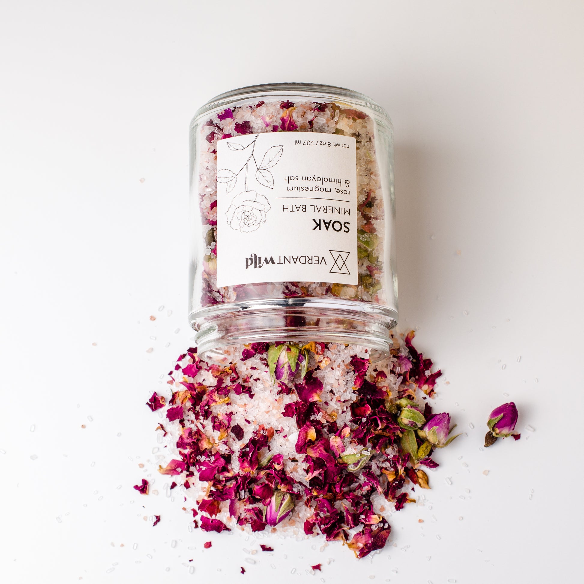 rose, epsom and himalayan bath salts open and spilled out to show texture