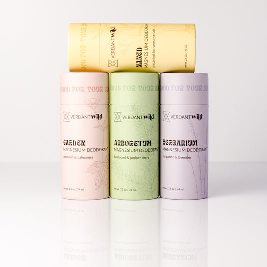Magnesium deodorant containers in different scents on a white background