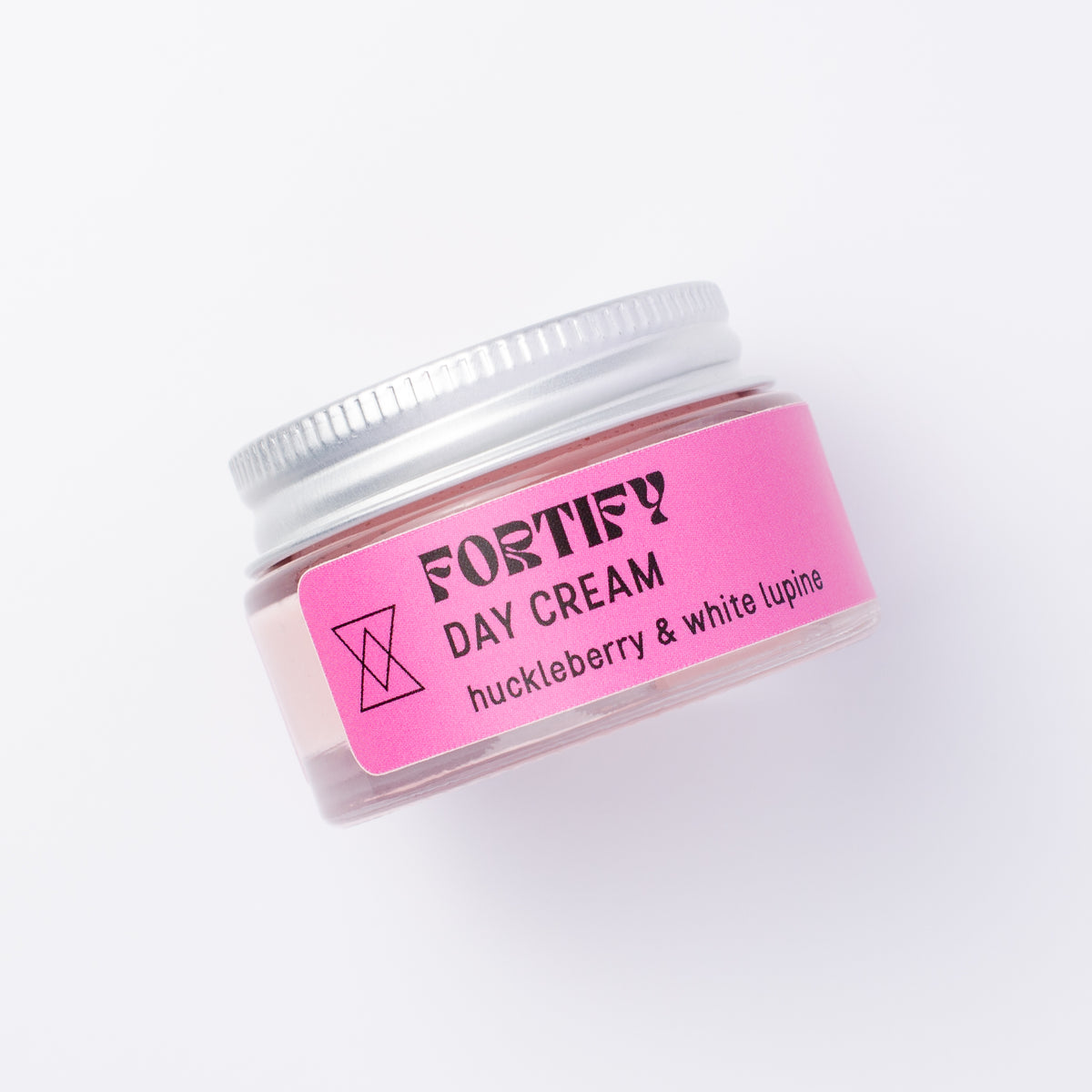 A small clear jar of Fortify Day Cream with a silver lid and a bright pink label, photographed on a clean white background.