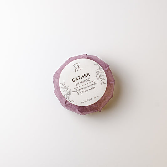 round shampoo bar with 'Gather' branding on a white background