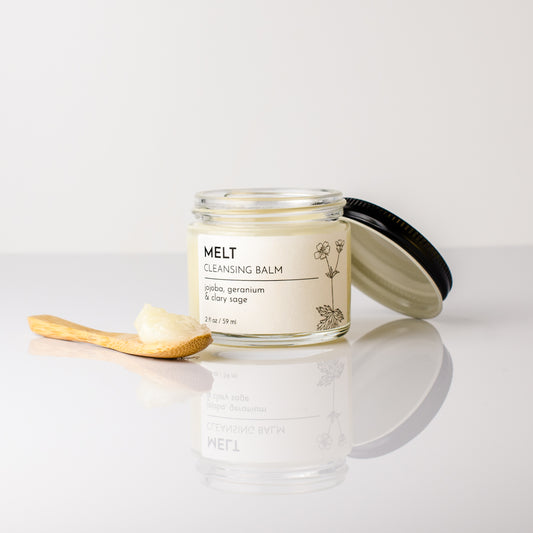 cleansing balm jojoba castor geranium clary sage open and spoonful to show texture