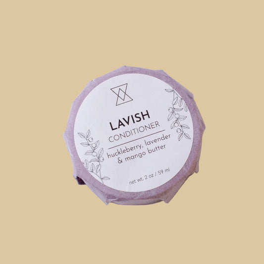 Lavish Conditioner soap bar wrapped in a light purple paper sleeve with a white circular label, photographed on a clean background.
