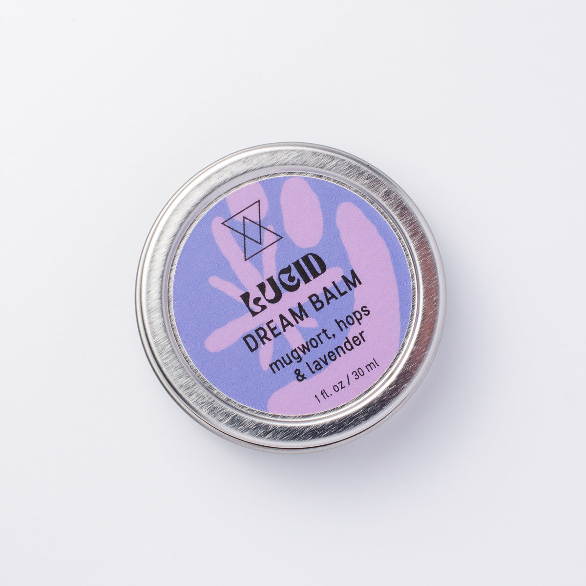 A round silver metal tin of LUCID Dream Balm with a lavender and blue label, photographed from above on a clean white background.