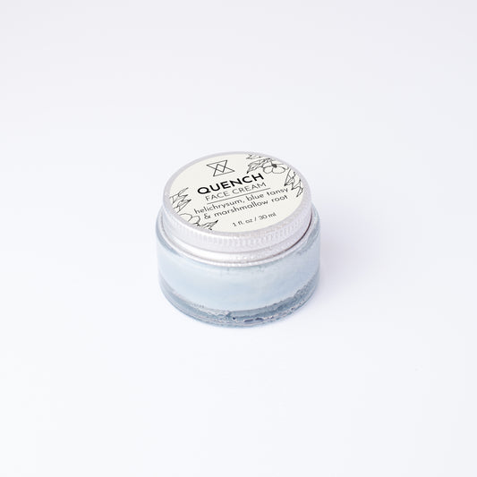 Jar of face cream labeled 'Quench' on a white background