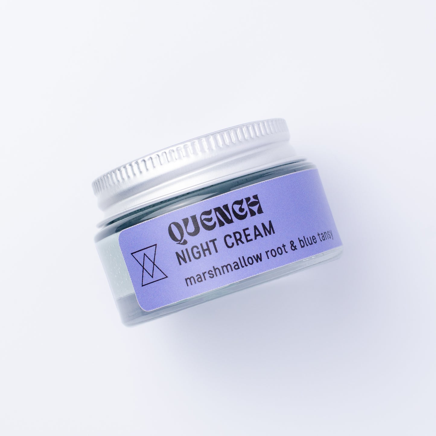 A small clear jar of Quench Night Cream with a blue label and silver lid, photographed on a clean white background.