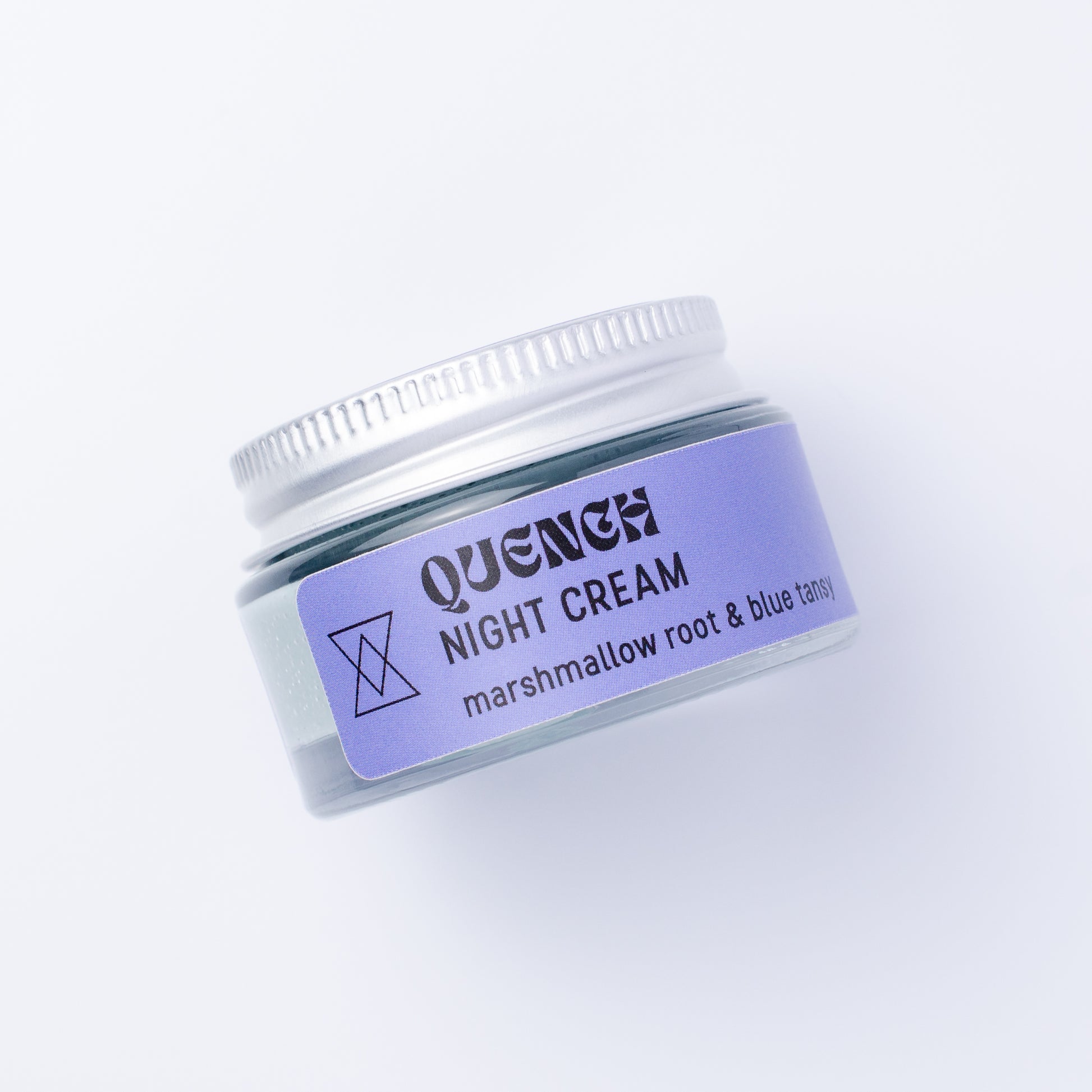 A small clear jar of Quench Night Cream with a blue label and silver lid, photographed on a clean white background.