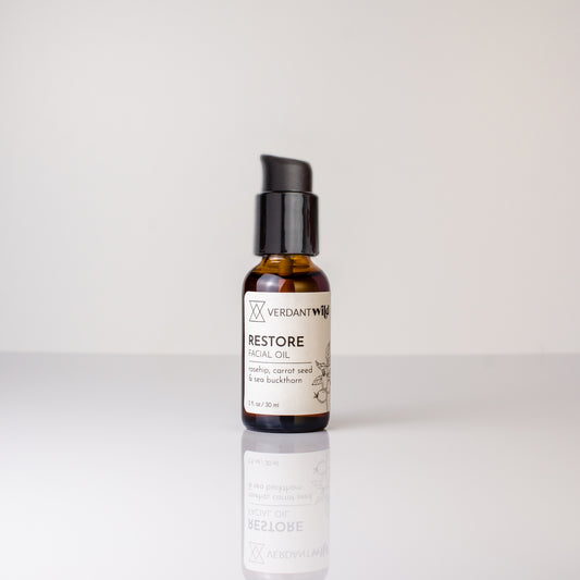 Bottle of Verdant Well Restore Oil on a white background