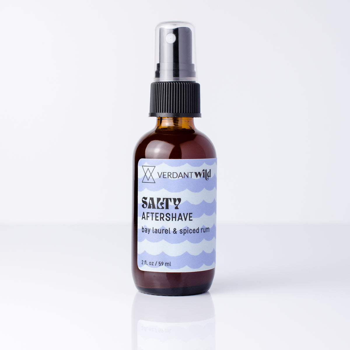 2 oz glass amber bottle of aftershave mist on reflective white surface