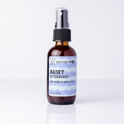 2 oz glass amber bottle of aftershave mist on reflective white surface