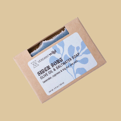 A kraft paper box of Verdant Wild Siren Song Olive Oil & Saltwater Soap, featuring a light ble label with blue botanical illustrations.