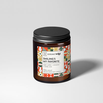 Candle jar with decorative label on a light gray background