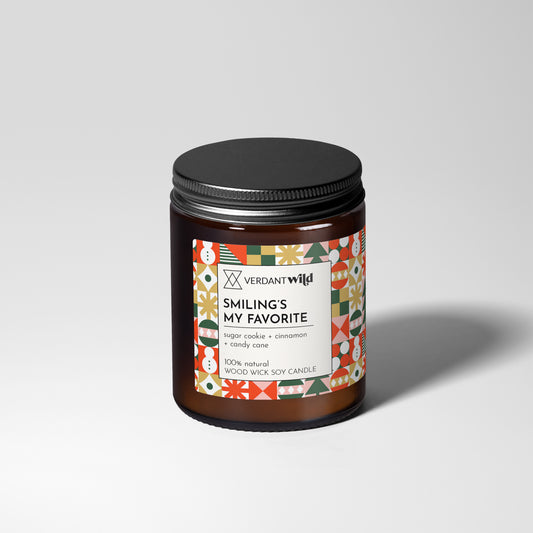 Candle jar with decorative label on a light gray background