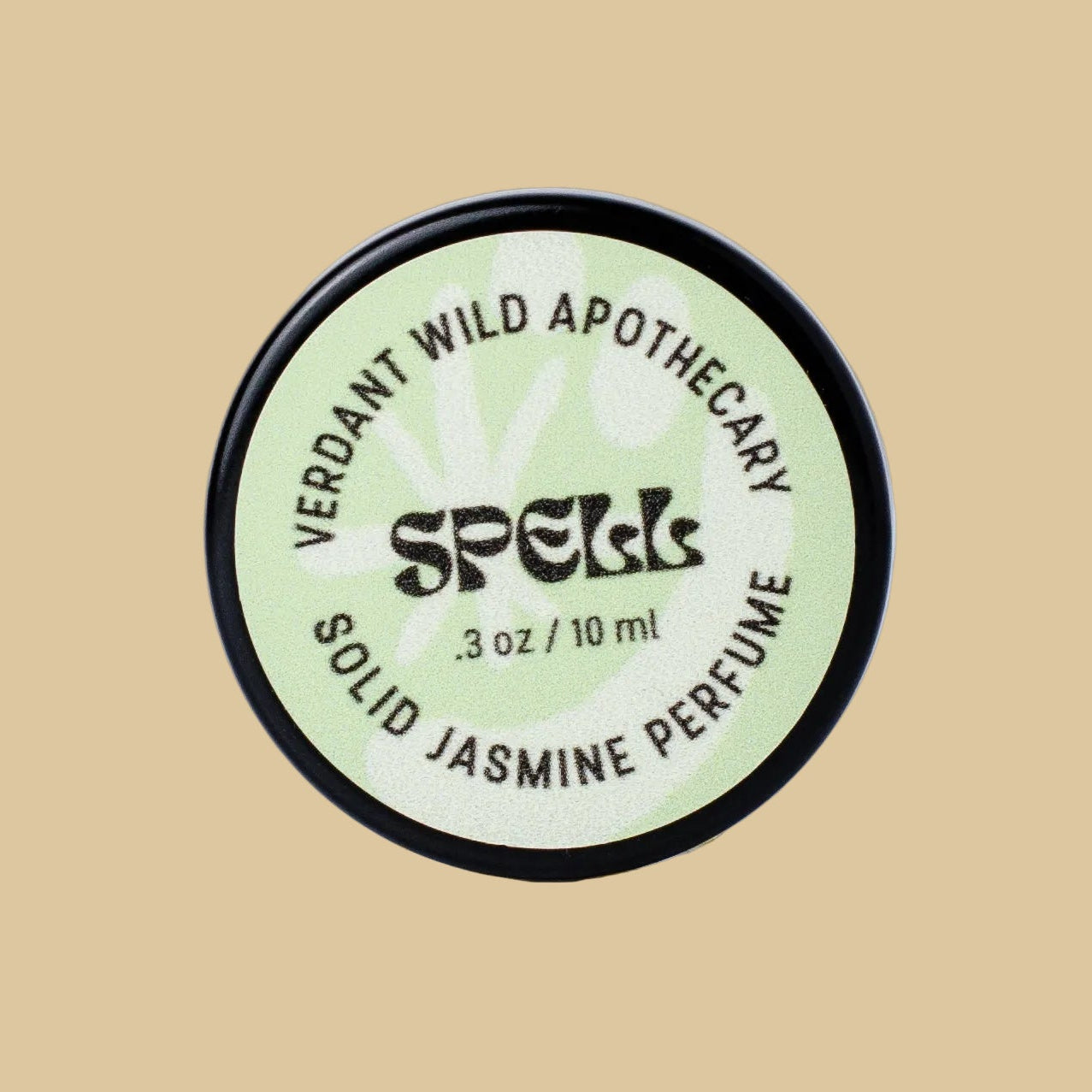 A round black-lidded jar of Verdant Wild Apothecary Spell Solid Jasmine Perfume, featuring a pale green label with black text.