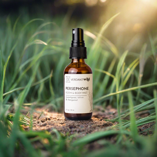 bergamot, vetiver and lavender room and body mist open sitting on soil in grass
