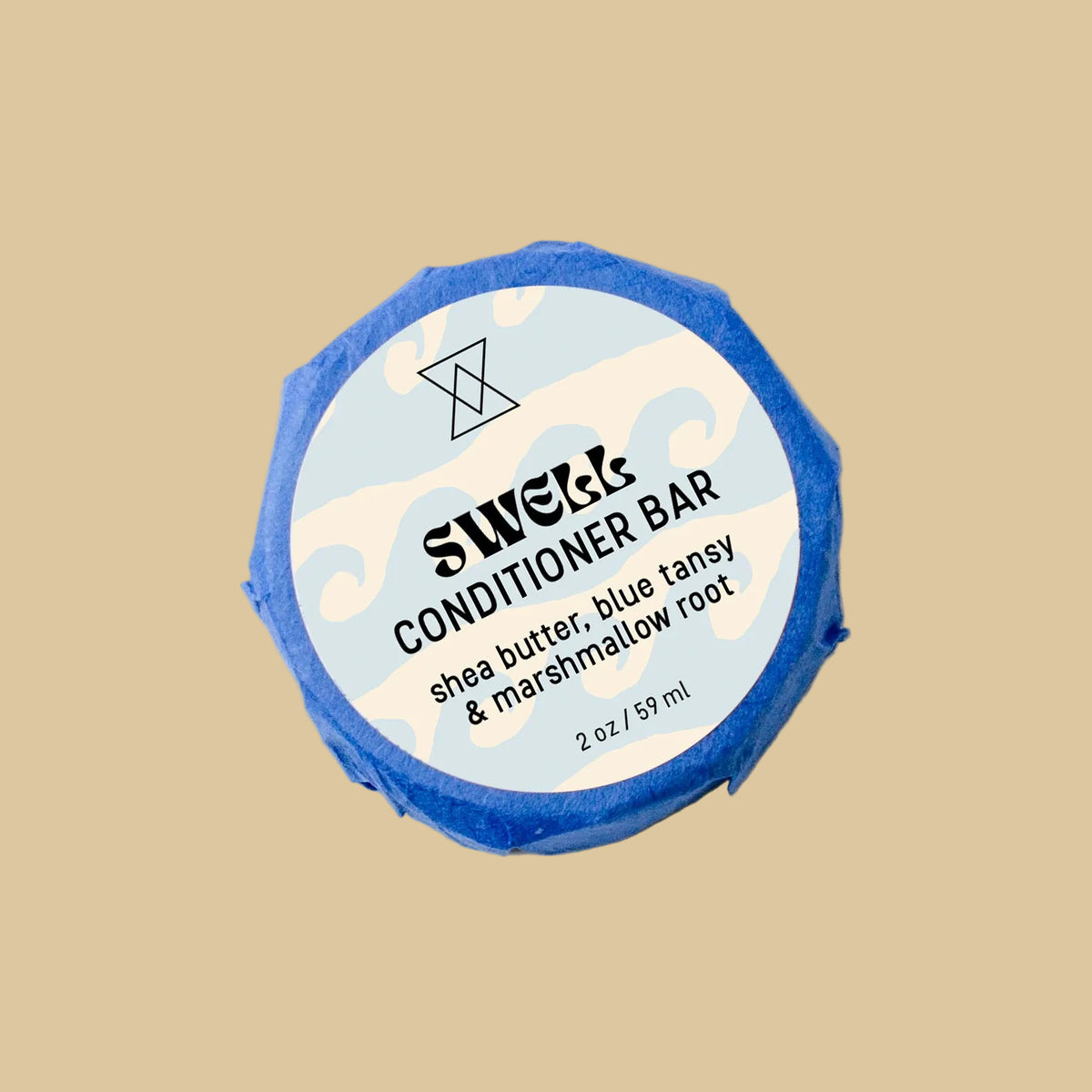 A round wrapped bar of Swell Conditioner soap on a clean background. The bar is wrapped in blue paper and features a white circular label with black text reading 'Swell Conditioner' and botanical line drawings.