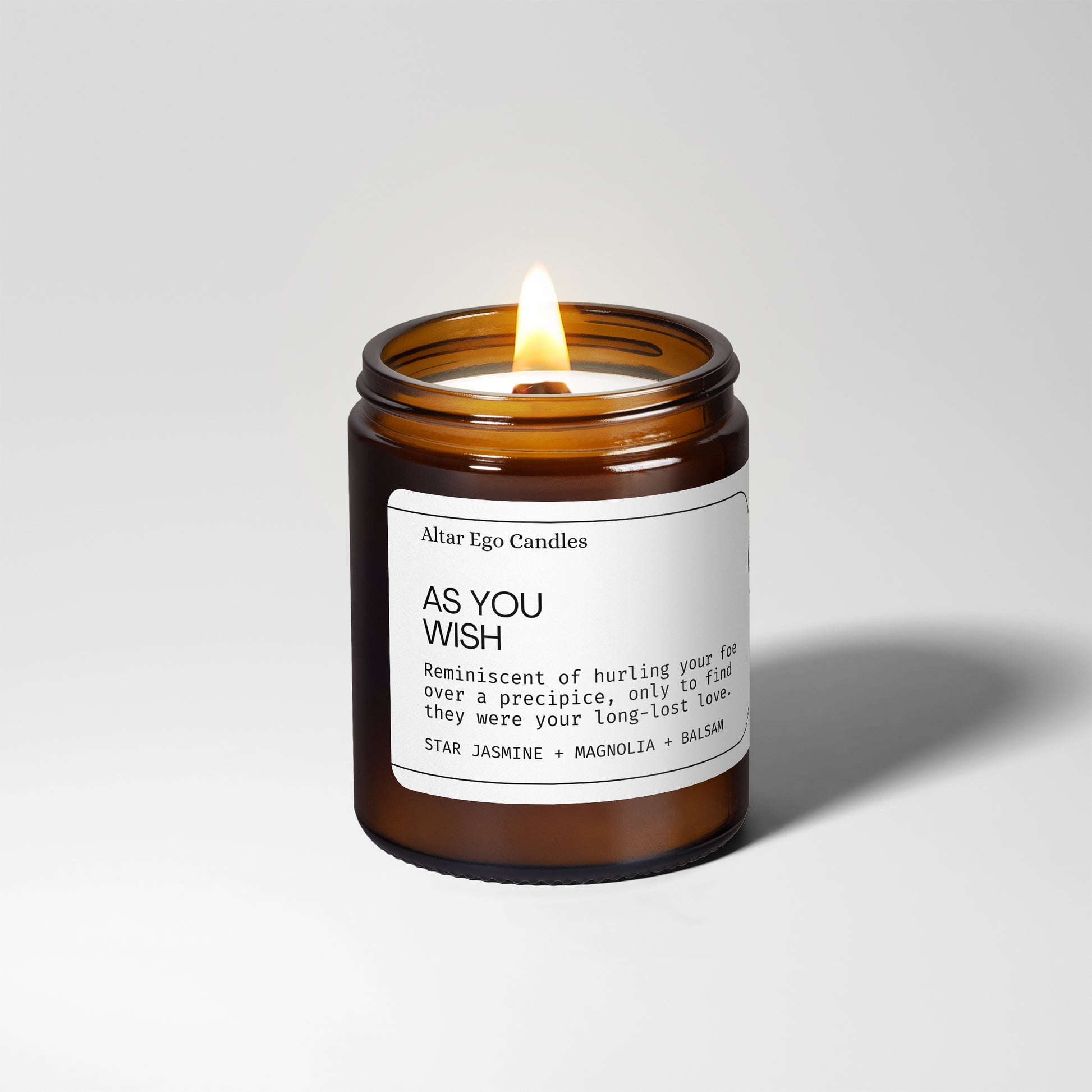 wood wick soy candle with  star jasmine, magnolia, white lily, and balsam  lit