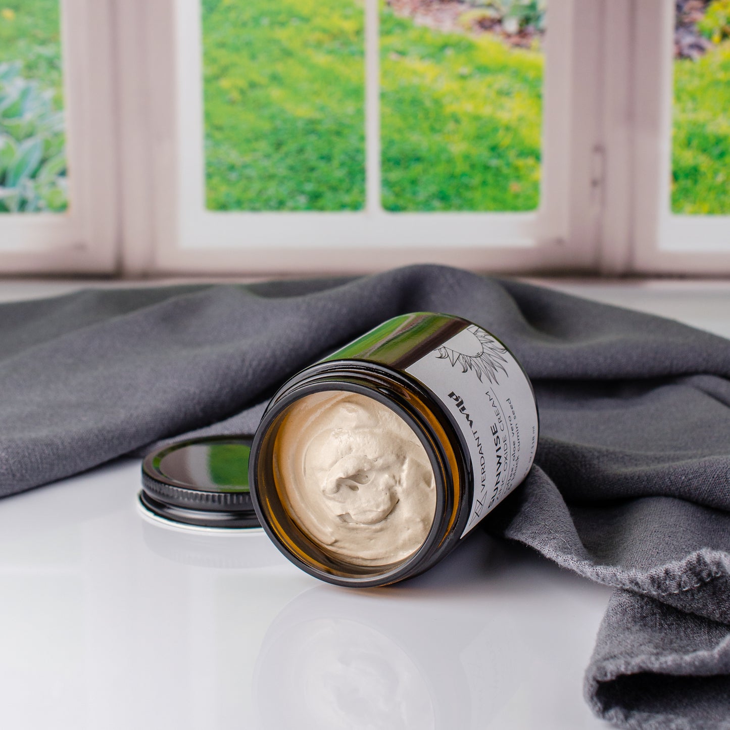 zinc oxide sun cream with coffee and black cumin seed oil open to show texture