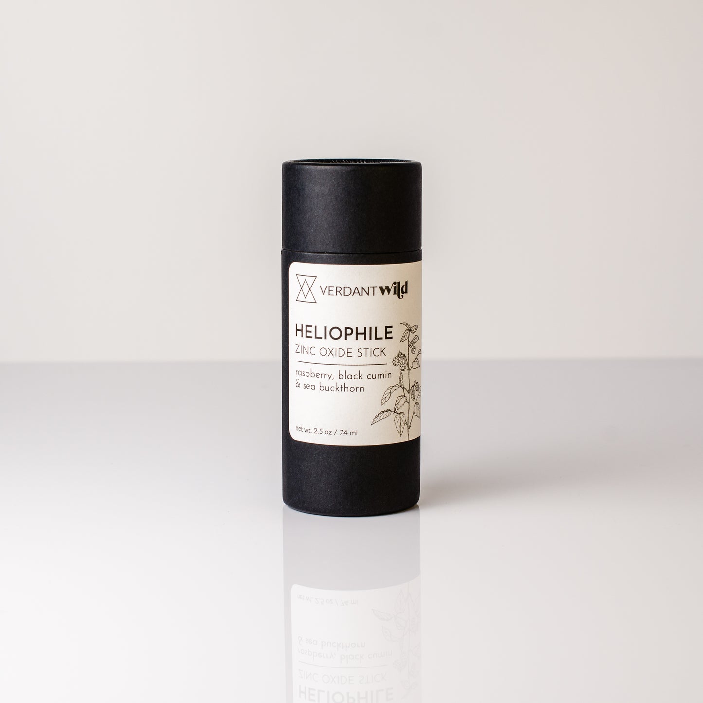 Black and white sunscreen stick with 'Verdant Wild' branding on a light gray background